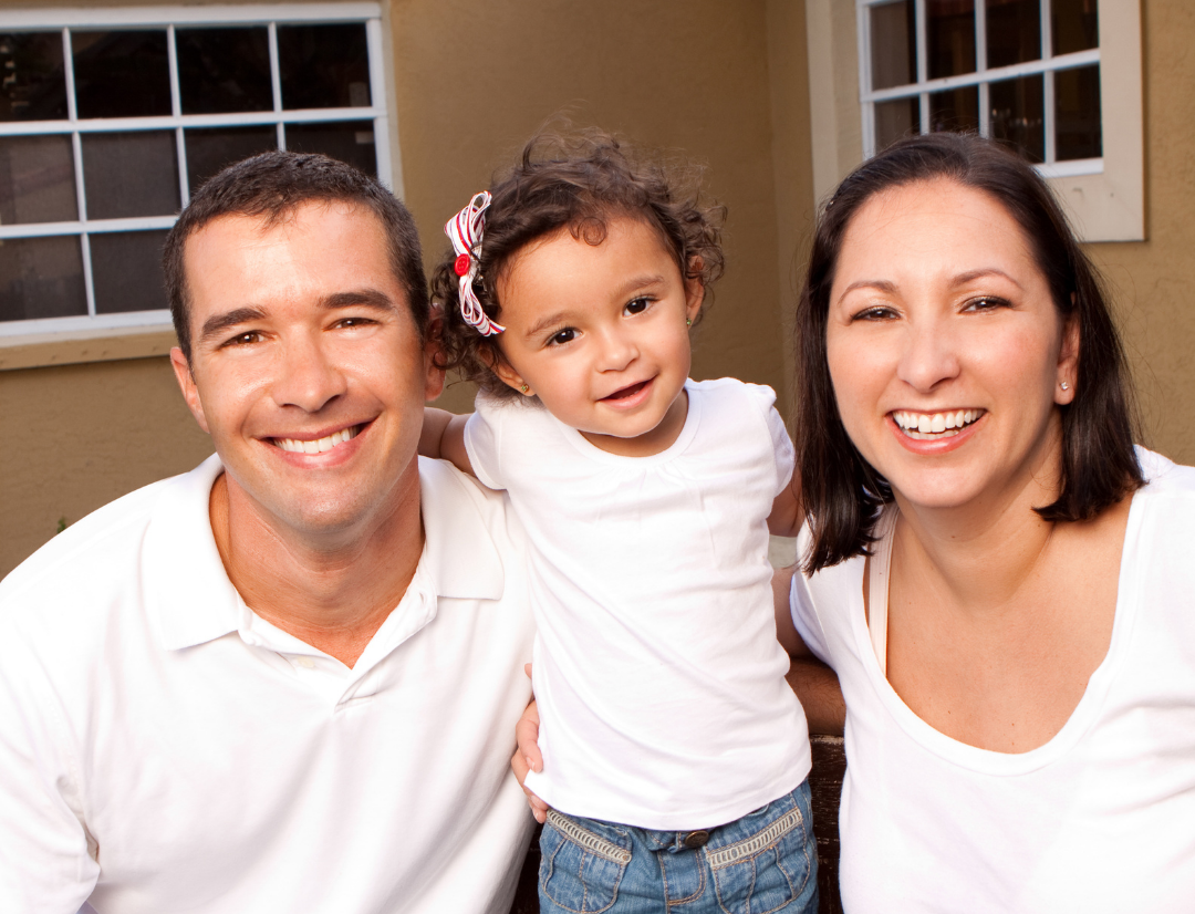 Couple with young child smiling